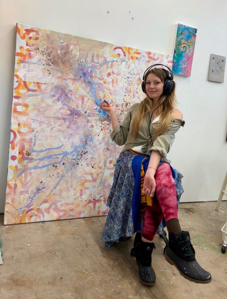 Contemporary Artist Lotus Heartsong in Studio Working on a large mixed media artwork in process